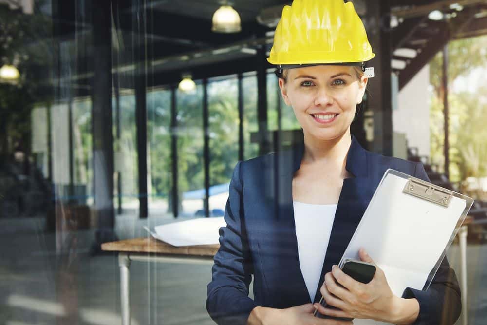 Woman with hard hat and checklist